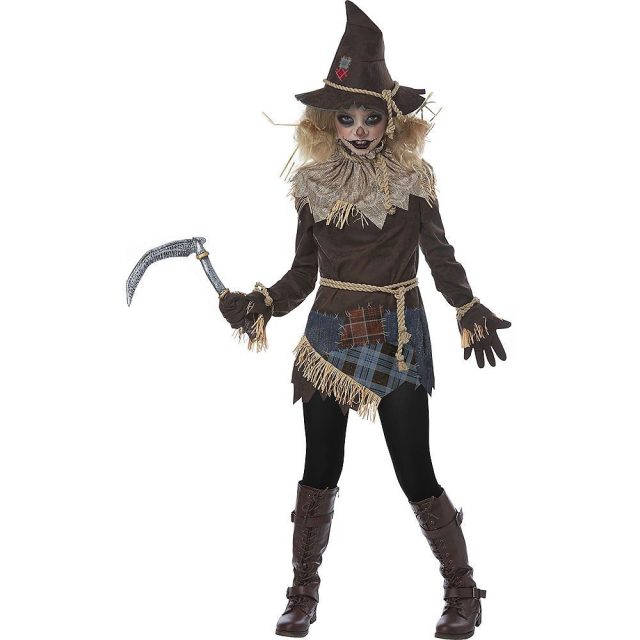 woman in a scary scarecrow costume holding a fake scythe, ready for Halloween trick-or-treating